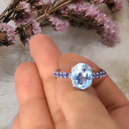 Sky Blue Topaz Ring With Blue Sapphire Gemstones..